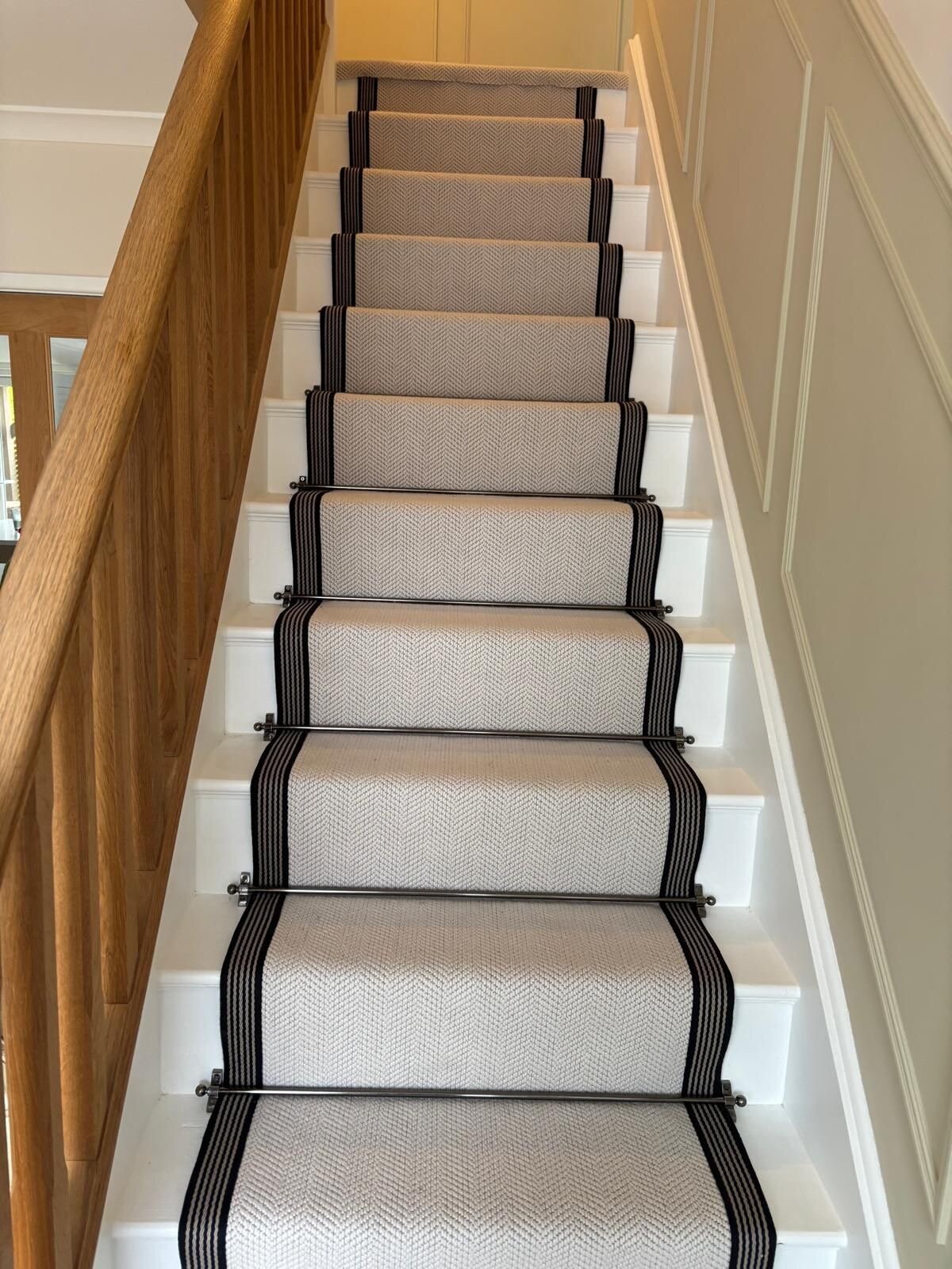 Classic elegance with Chartwell Fibre Wool Herringbone stairs with pewter stair rods